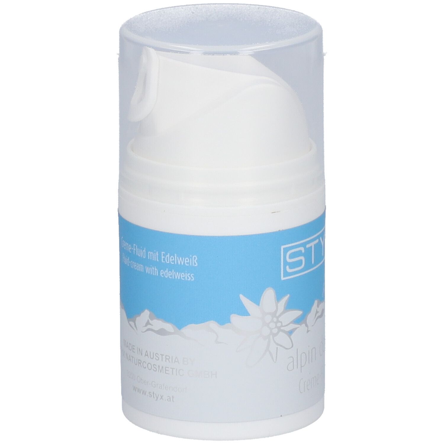 Distributeur blanc avec étiquette bleue. Inscription STYX, fleur des Alpes, alpin derm Creme-Fluid. Avec Edelweiss & Lait de brebis.