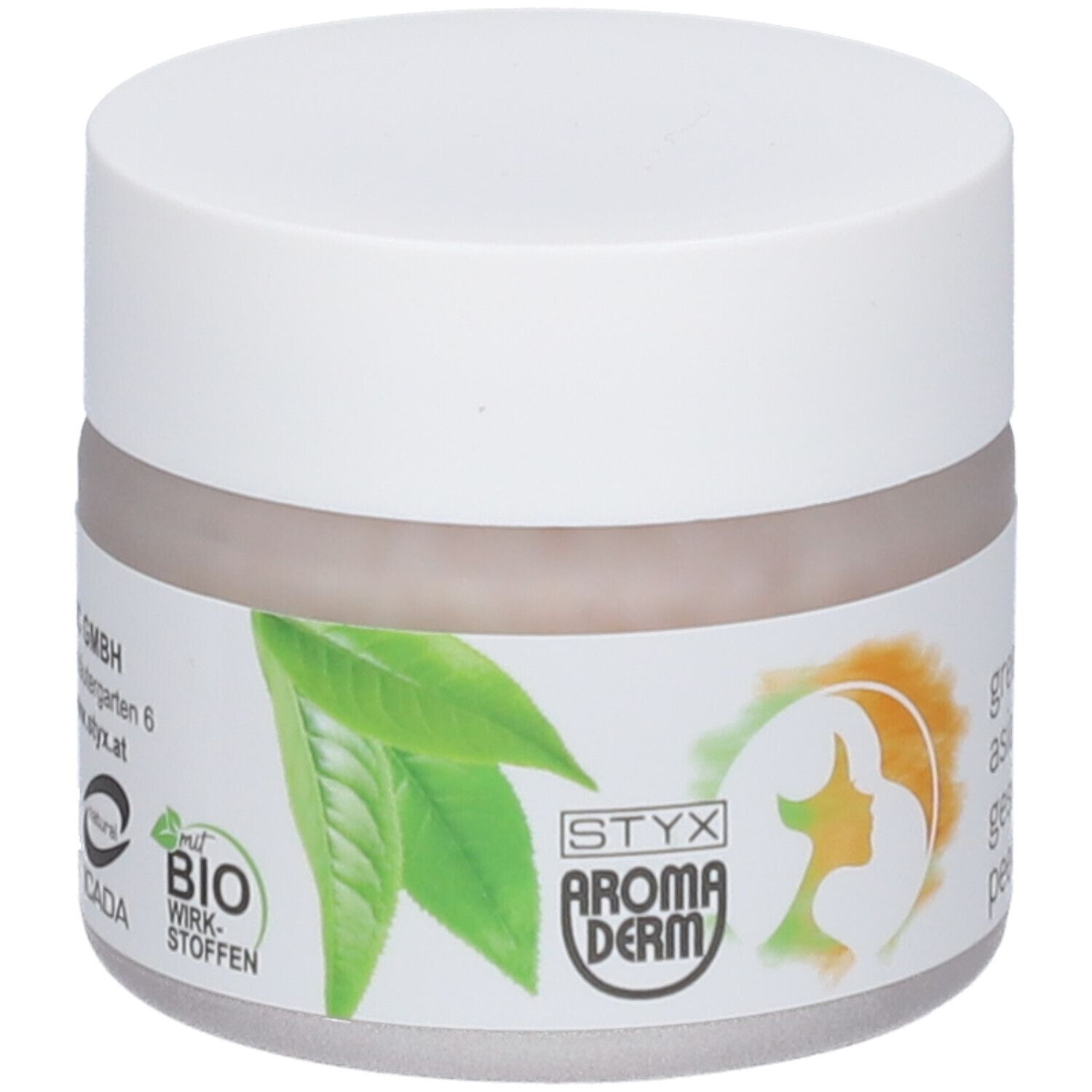 Pot de crème avec couvercle blanc. Étiquette avec feuilles vertes, silhouette de visage féminin et texte.