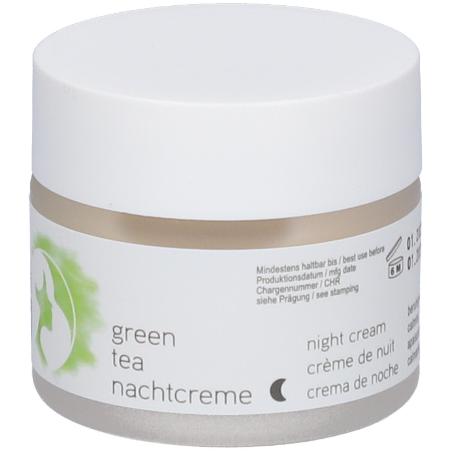 Pot de crème avec couvercle blanc. Étiquette : crème de nuit au thé vert, texte en allemand, français, italien, vegan.
