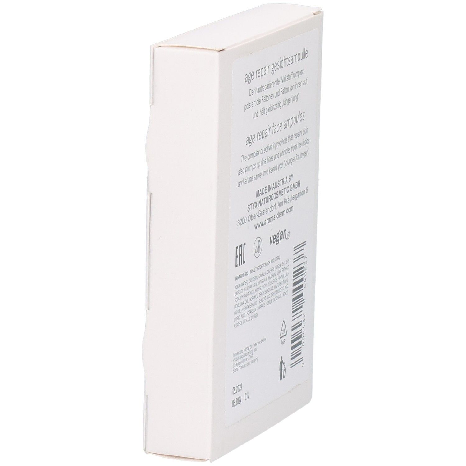 Vue latérale de la boîte blanche. Texte avec informations produit et label vegan. Adresse fabricant et numéro de lot.