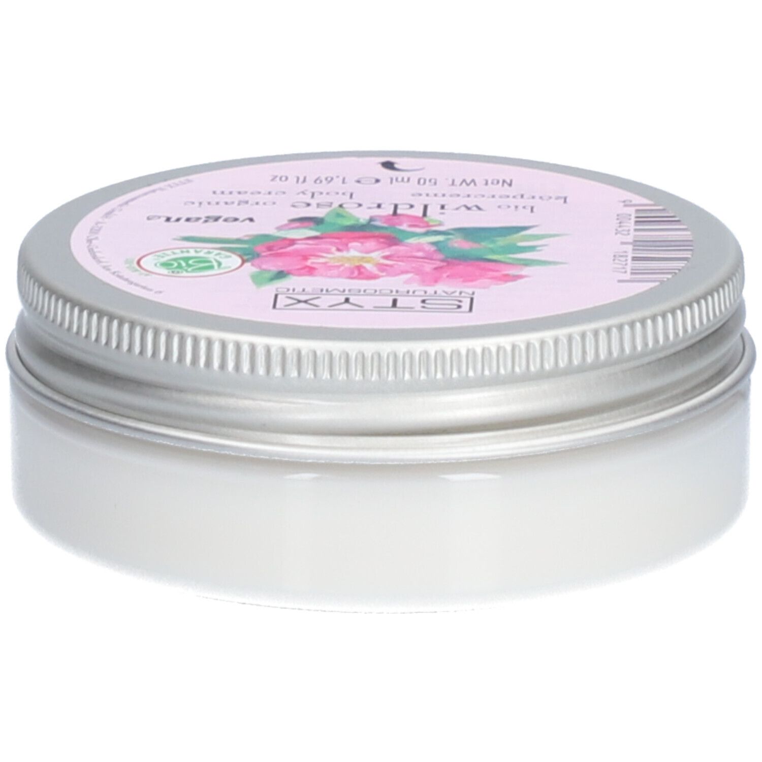 Pot de crème avec couvercle. Sur le couvercle : STYX Naturkosmetik, Wildrose, vegan. Étiquette rose avec fleurs de rose. Pot en métal.