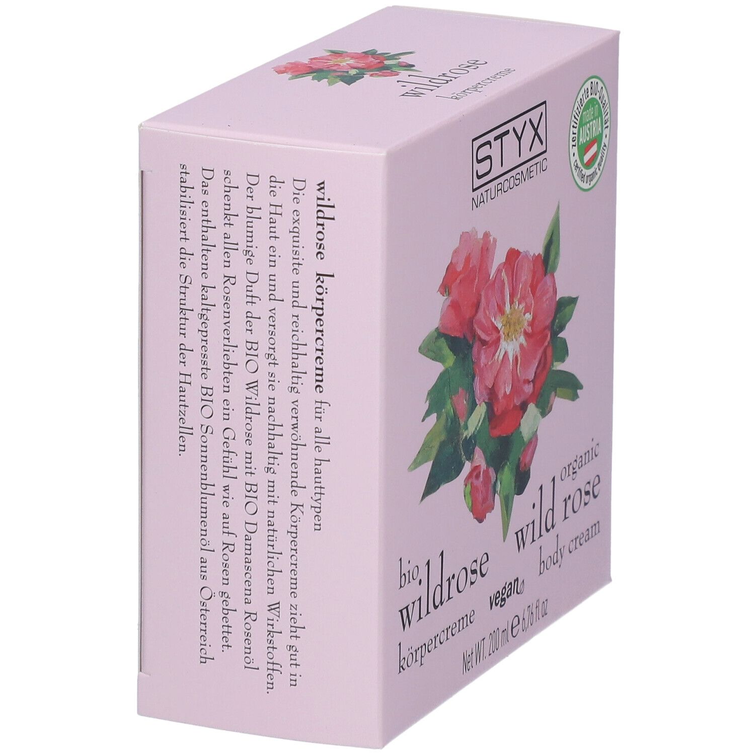 Boîte rose en biais. Logo STYX, illustration de rose sauvage, texte : crème pour le corps à la rose sauvage.