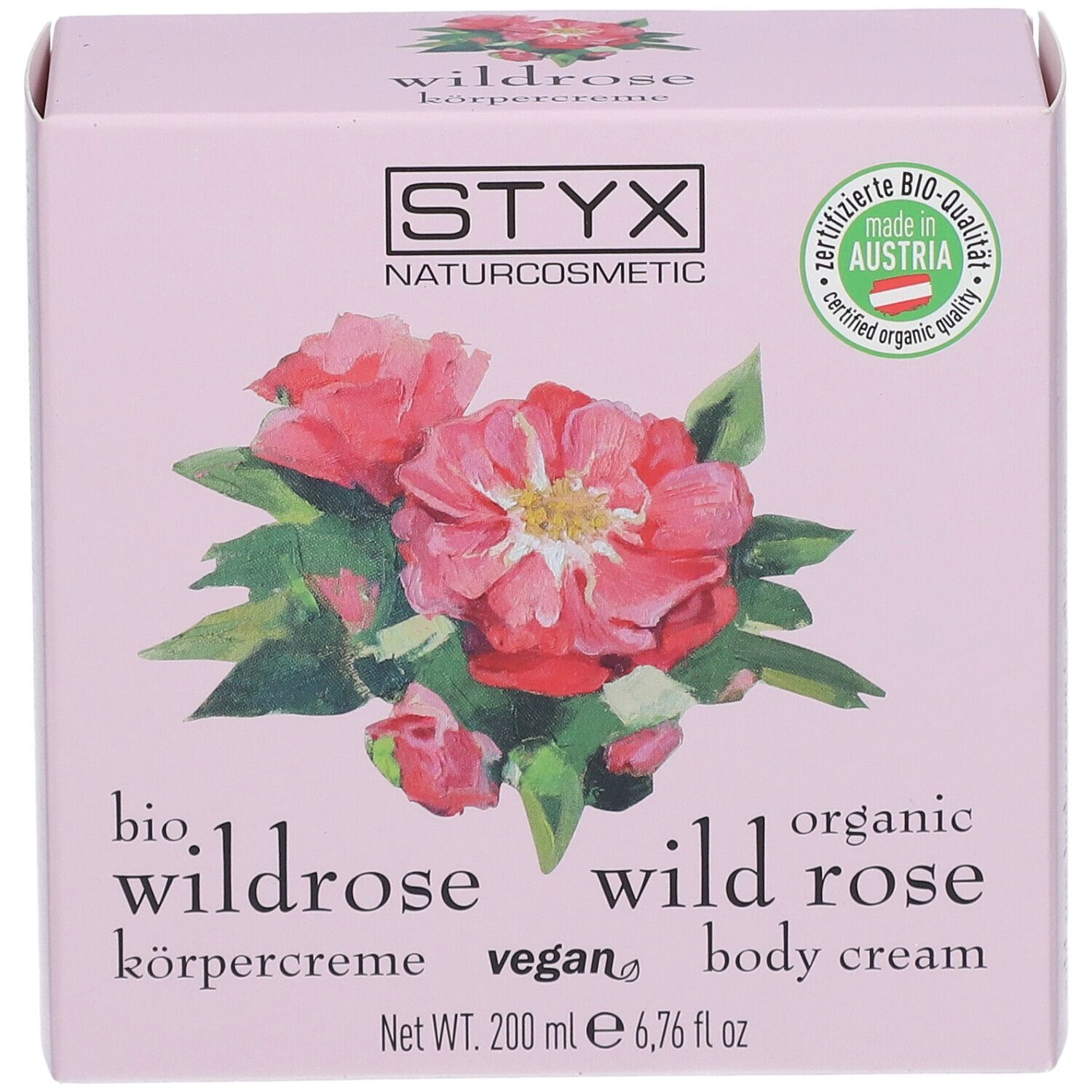 Boîte rose avec logo STYX, illustration de rose sauvage, texte : crème pour le corps à la rose sauvage, 200 ml.