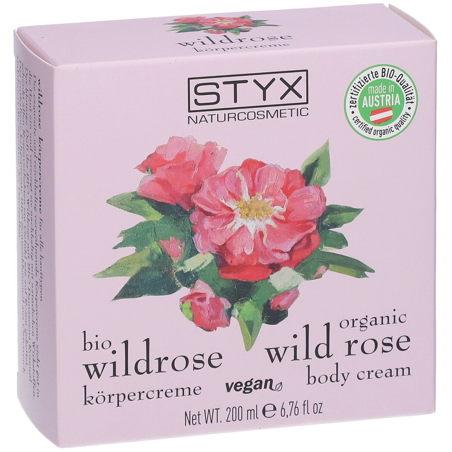 Boîte rose avec logo STYX, illustration de rose sauvage, texte : crème pour le corps à la rose sauvage, 200 ml.