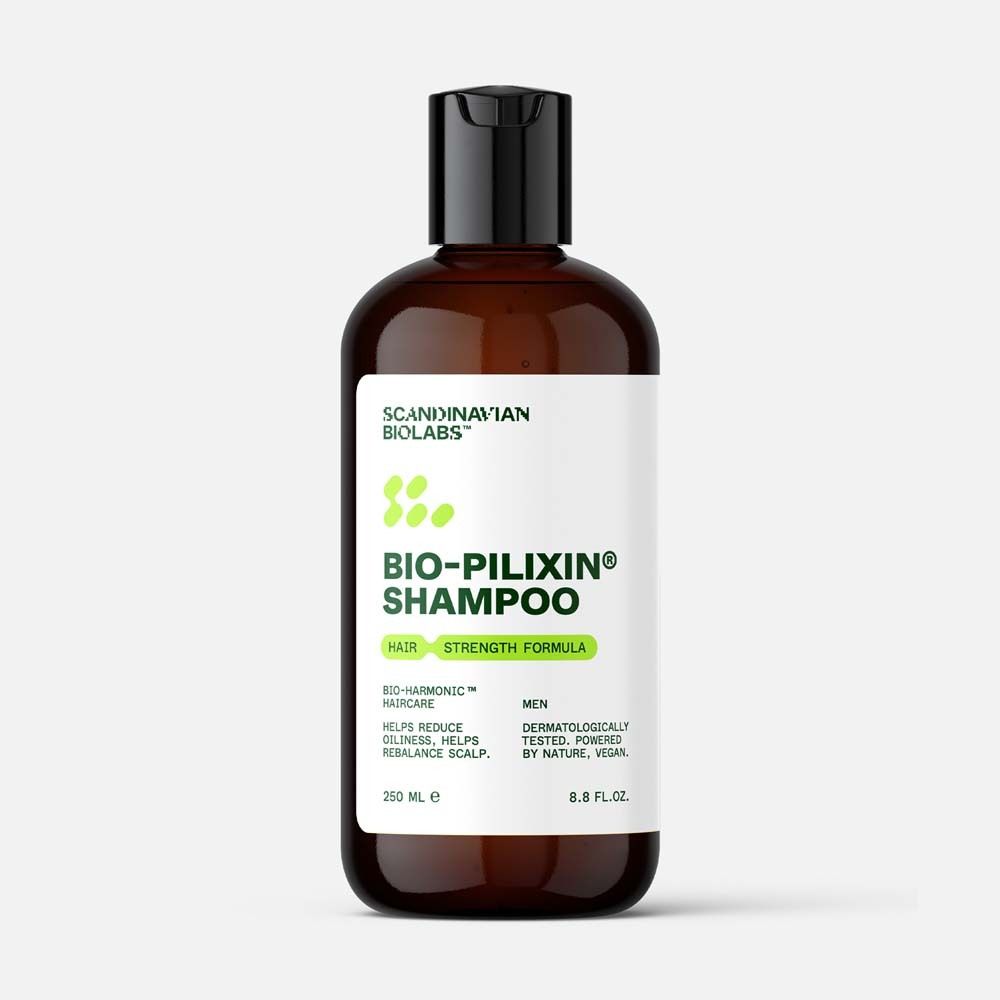 Flacon de shampooing brun avec bouchon noir. Étiquette "Bio-Pilixin Shampoo" et logo. 250 ml.