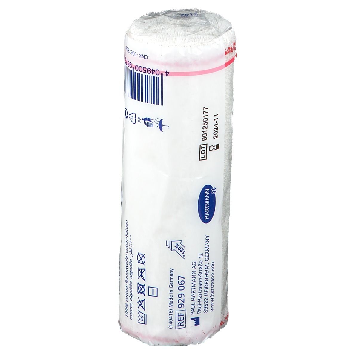 Rouleau de bandage dans son emballage. Inscription: Hartmann, REF 929 067, LOT 901250177, 2024-11. Emballage avec symboles.