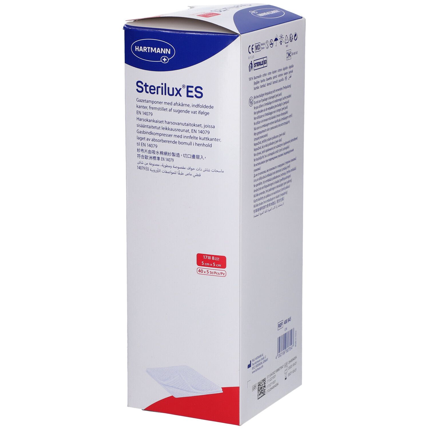 Emballage de Sterilux ES compresses. Boîte blanche avec texte bleu et rouge. Logo Hartmann. Texte multilingue.