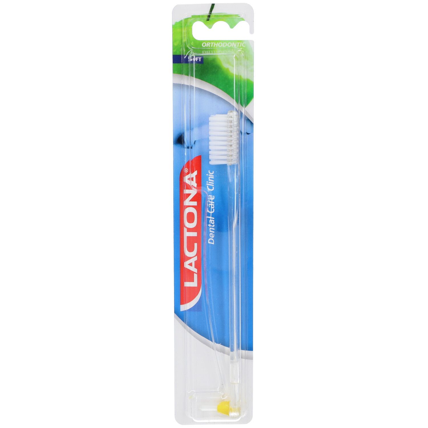 Brosse à dents sous blister. Manche transparent, tête blanche. Inscription : Lactona Dental Care Clinic. Point jaune sur le manche.