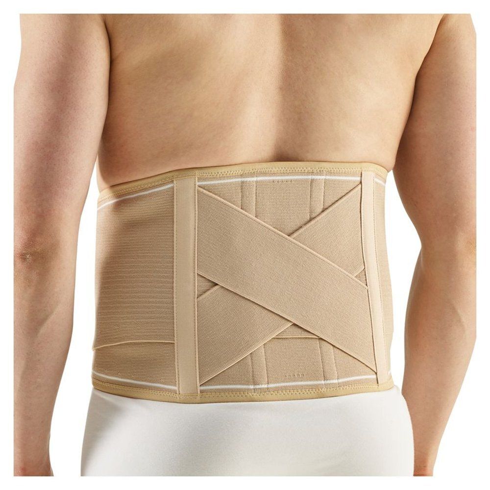 Ceinture de soutien lombaire beige avec sangles croisées. Bordure blanche. Portée par une personne.