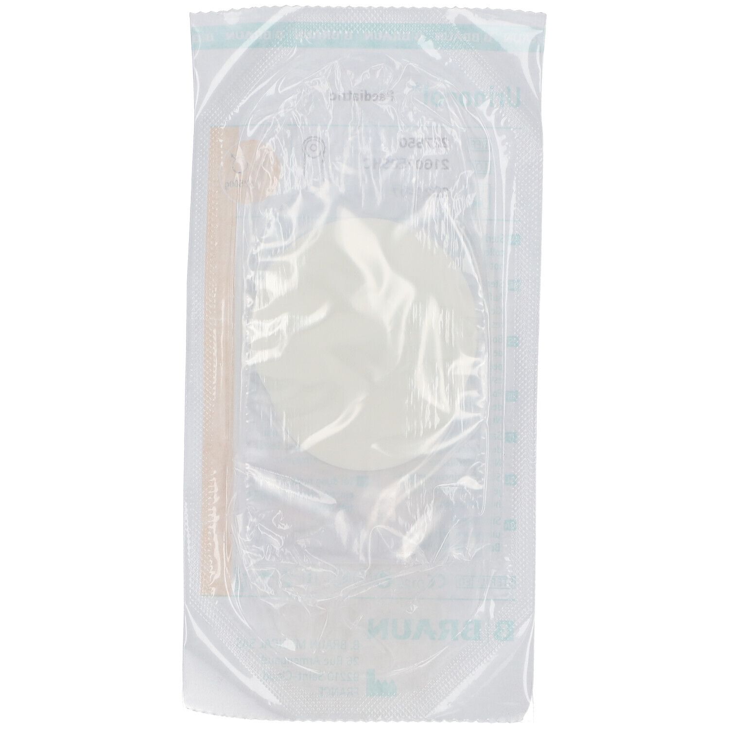 Emballage transparent contenant du matériel médical. Contenu partiellement visible : élément rond blanc et tube.