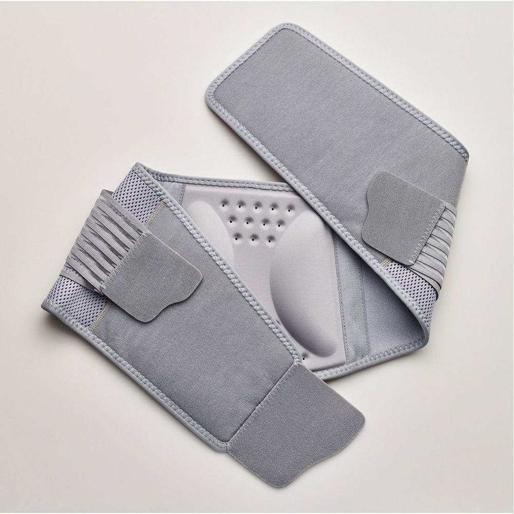 Ceinture lombaire grise et blanche. Emballage avec image du produit. Marque FUTURO et logo 3M visibles.