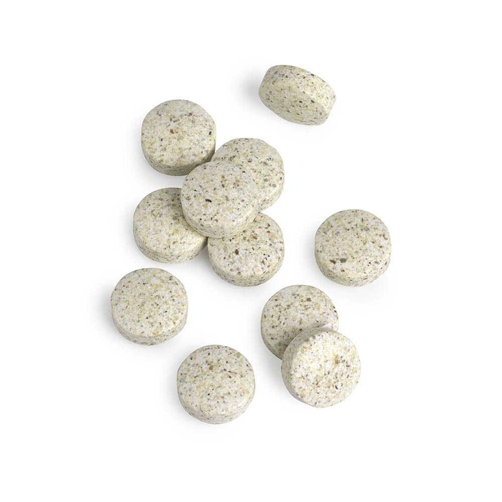 Gros plan sur les comprimés. Comprimés ronds beiges avec de petits points.