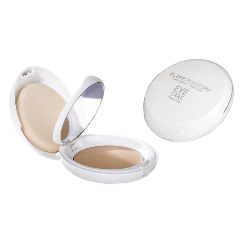 Poudre de teint compacte. Boîtier ovale blanc avec miroir et applicateur. Inscription: EYE CARE.