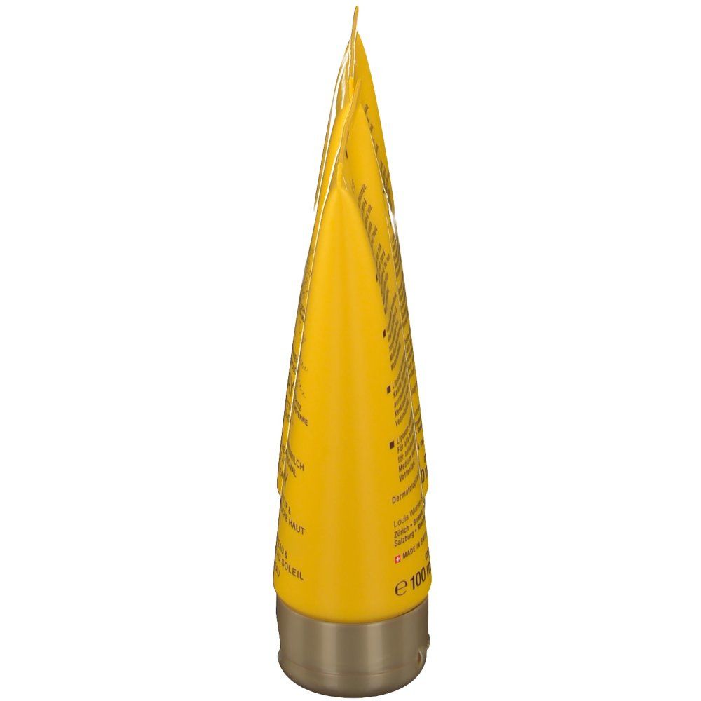 Tube jaune, bouchon doré. Texte sur le tube. Impression: e 100 ml.