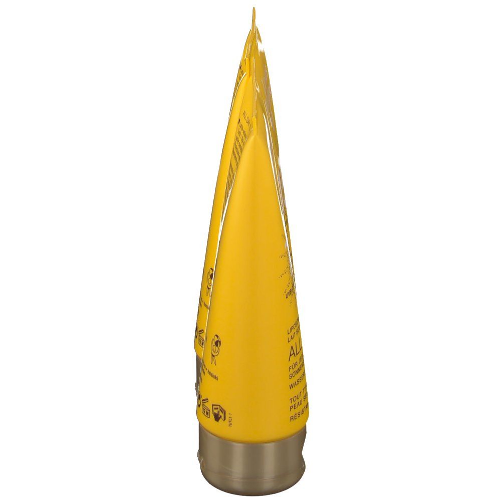 Tube jaune, bouchon doré. Texte sur le tube.