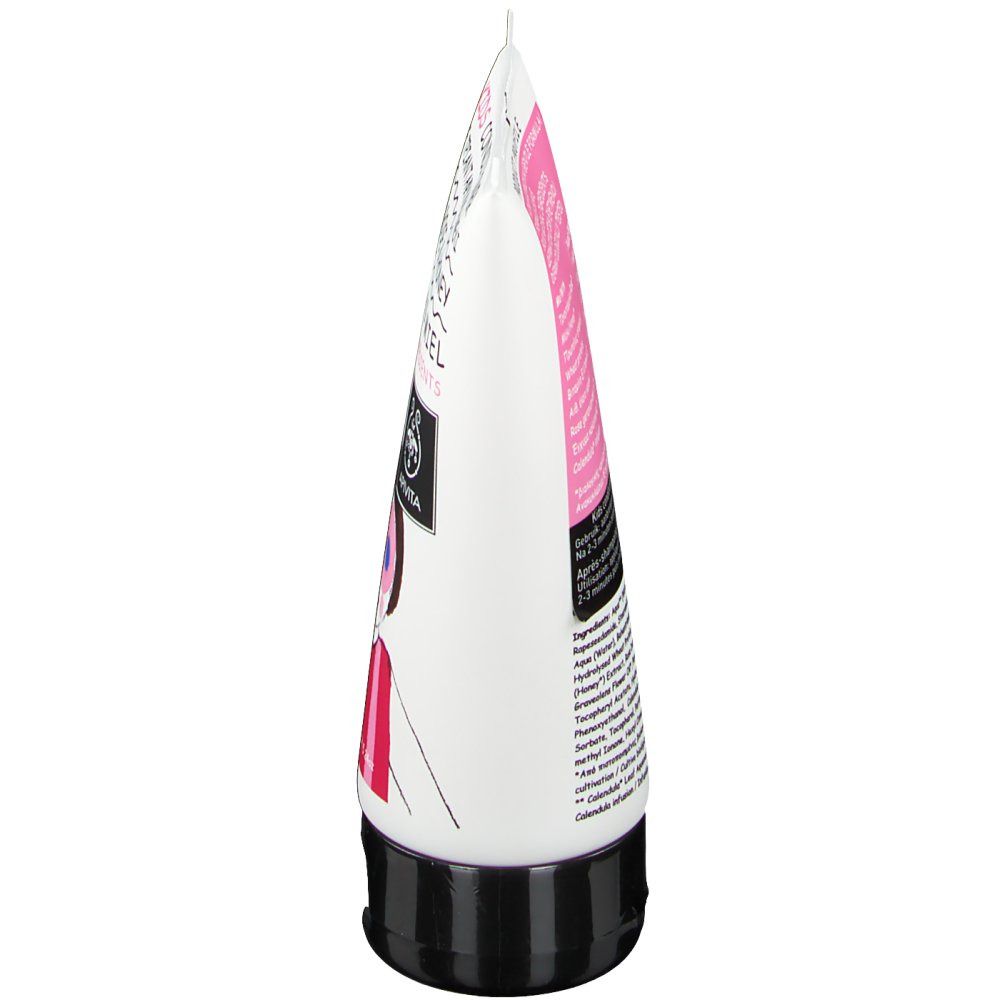 Vue latérale d'un tube blanc avec bouchon noir. Détails roses et noirs. Texte sur le tube.