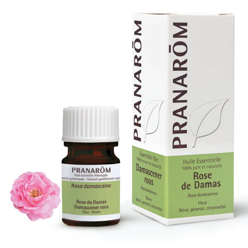 Flacon, emballage et rose. Flacon brun avec bouchon blanc. Emballage avec marque PRANAROM.