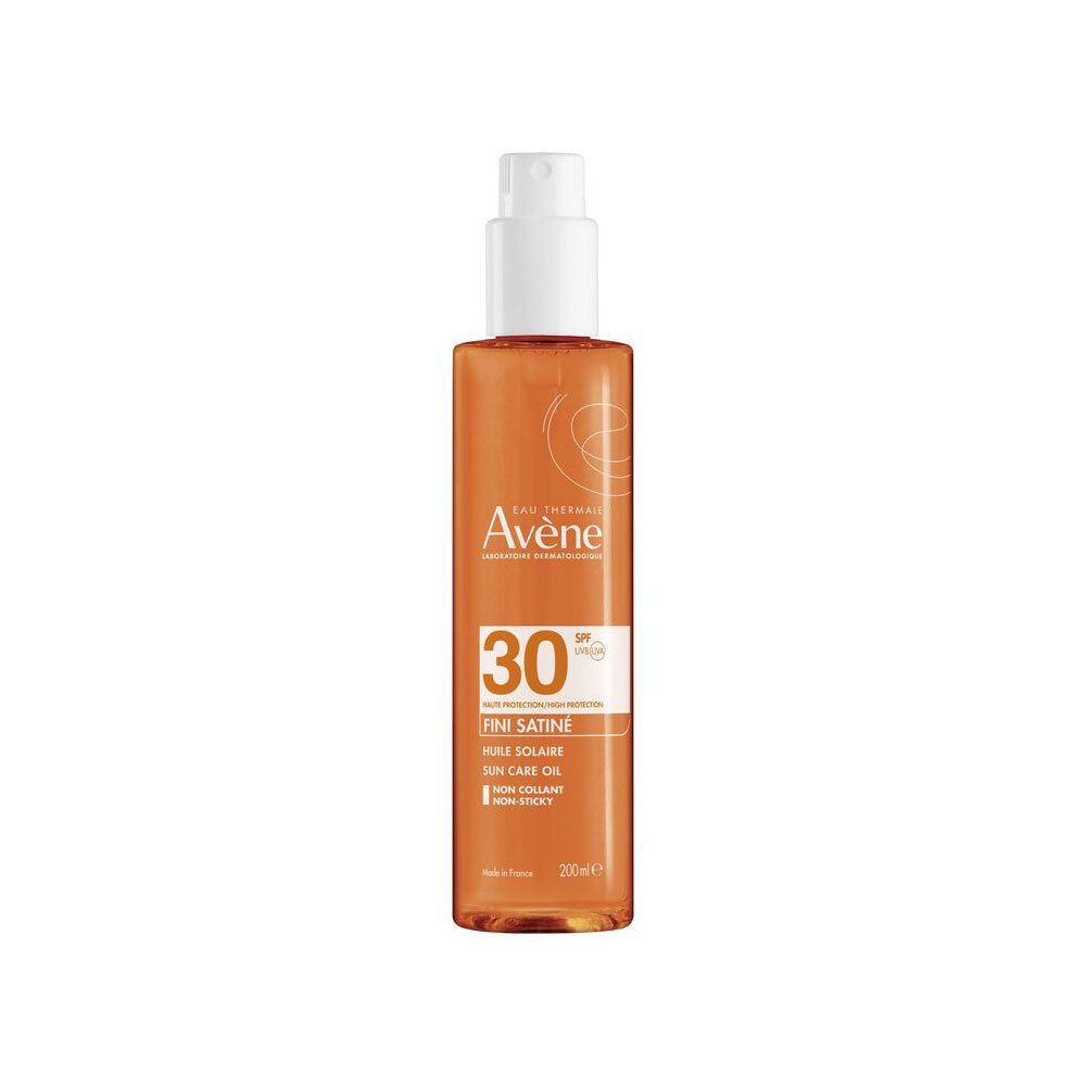Flacon spray d'huile solaire avec tête blanche. Huile orange visible. Inscription: Eau Thermale Avène, SPF 30, Huile satinée, Sun care oil.