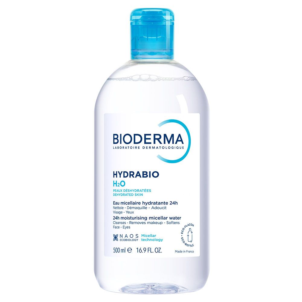 Flacon transparent avec bouchon bleu. Étiquette BIODERMA et Hydrabio H2O. Texte: Eau micellaire démaquillante, 500 ml.