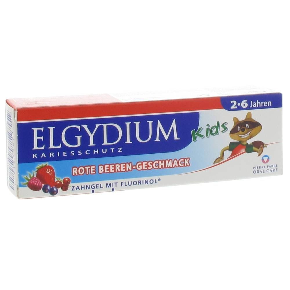 Emballage de produit d'hygiène bucco-dentaire pour enfants. Inscription ELGYDIUM Kids, protection contre les caries, goût fruits rouges. Contient du fluorinol. 2-6 ans.