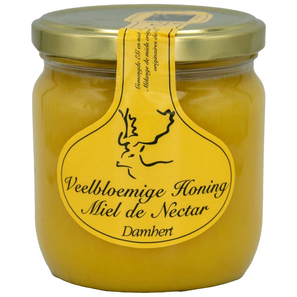 Bocal de miel de fleurs avec étiquette jaune et couvercle doré.
