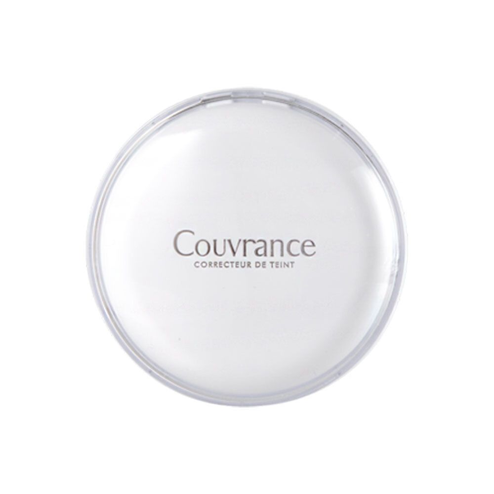 Boîtier de maquillage compact blanc rond fermé. Inscription Couvrance, Corrector de Teint.