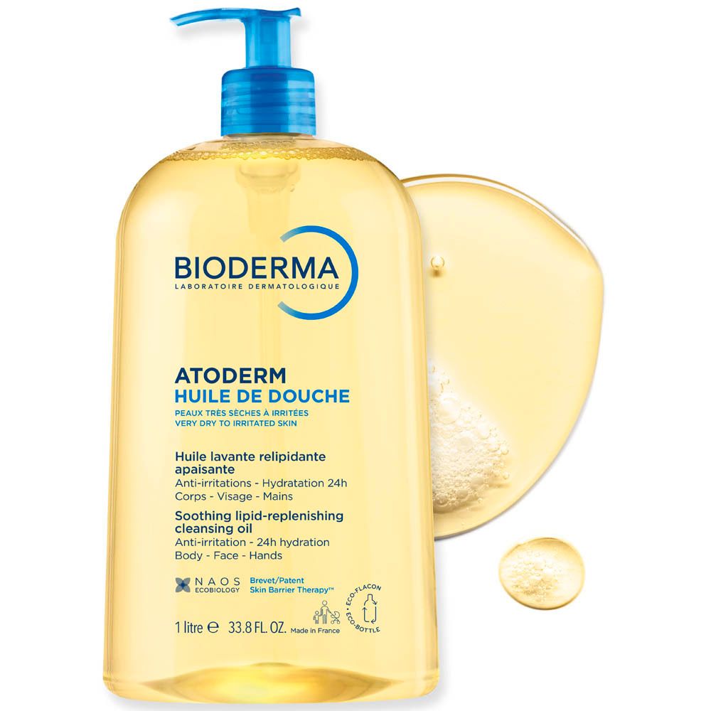 Flacon BIODERMA Atoderm Huile de douche avec éclaboussure d'huile. Liquide jaune, pompe bleue. Texte : Atoderm.