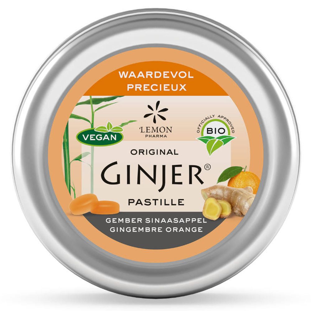 Boîte ronde de pastilles Ginjer. Étiquette orange avec nom du produit, illustrations de gingembre et d'orange, label bio.