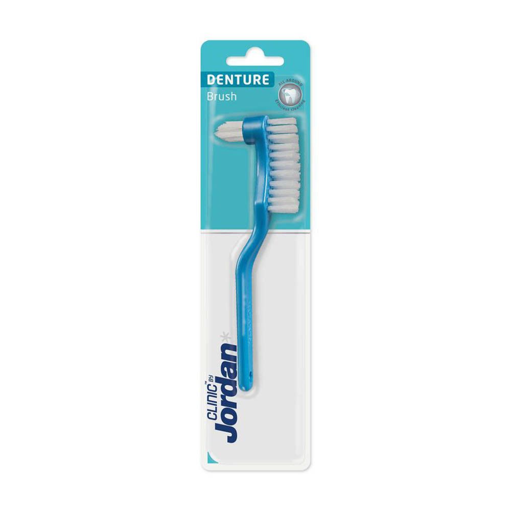 Brosse à dents pour prothèses en emballage blister. Brosse bleue avec tête de brosse blanche. Marque Jordan Clinic.