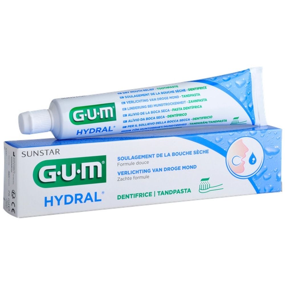 Tube et boîte de dentifrice GUM HYDRAL, blanc et bleu. Sur la boîte : symbole de bouche, inscription 'Tandpasta'.