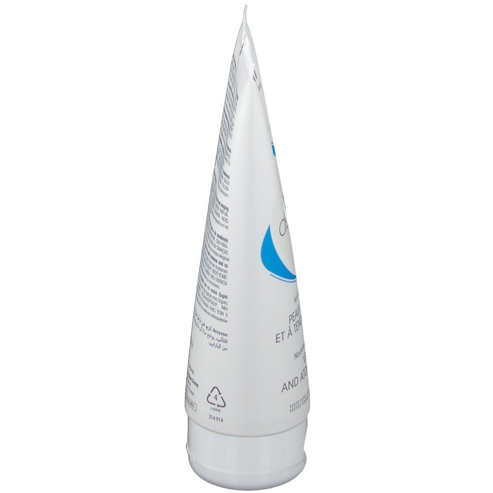 Vue latérale d'un tube blanc. Texte et graphisme bleu. Comprend un bouchon.