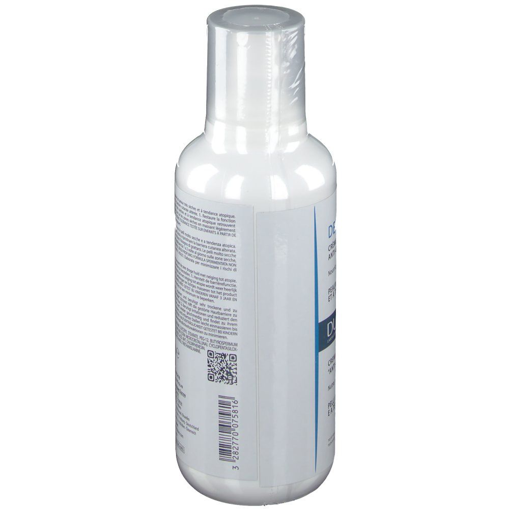 Flacon blanc avec texte. Vue latérale. Crème DUCRAY DEXYANE. Texte multilingue.