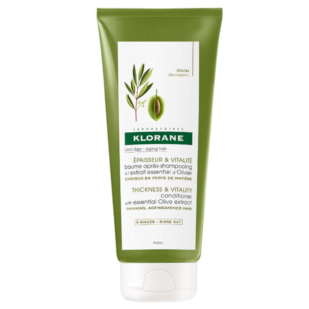 Tube verte de Klorane Shampoo Olivenbalsam. Illustration d'un rameau d'olivier et texte.