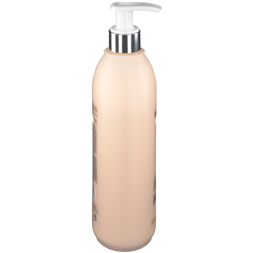 Flacon beige avec pompe, vue latérale. Texte sur le côté.