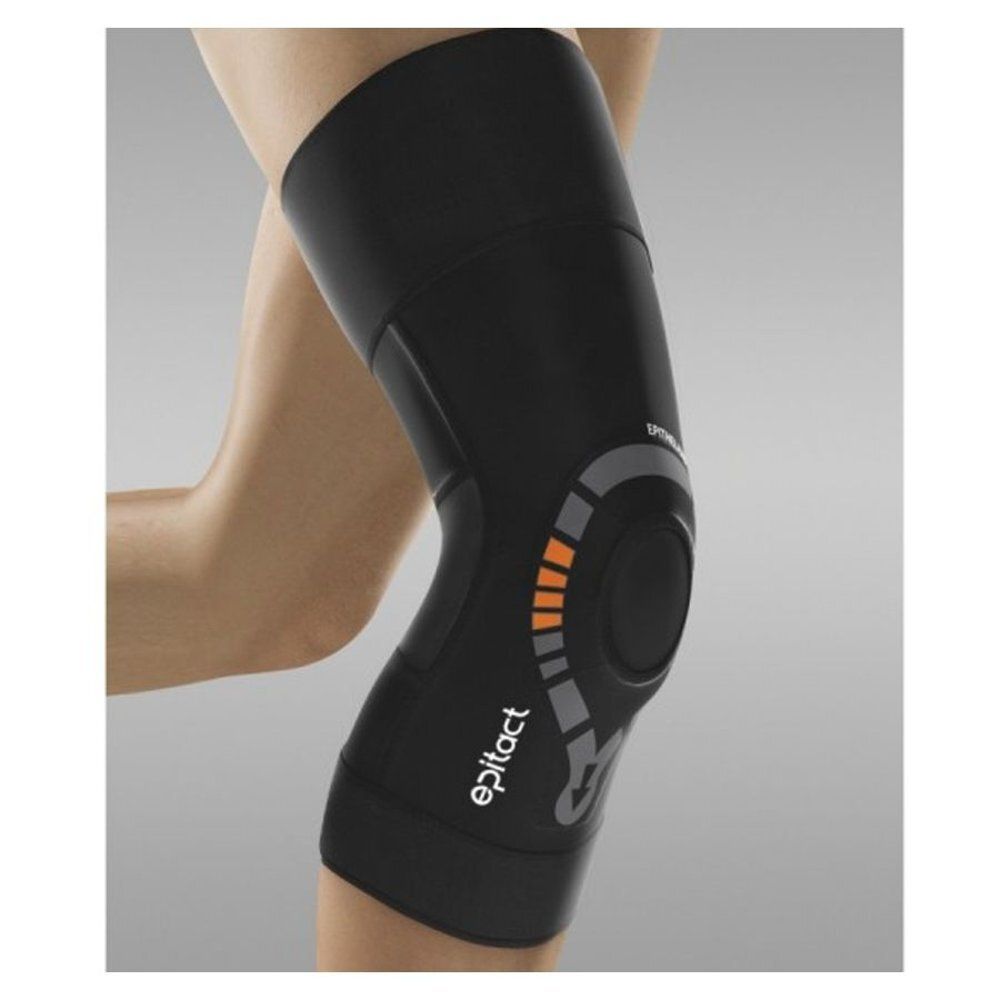 Genouillère Epitact noire sur une jambe. Logo visible. Détails gris et orange. Matériau souple.
