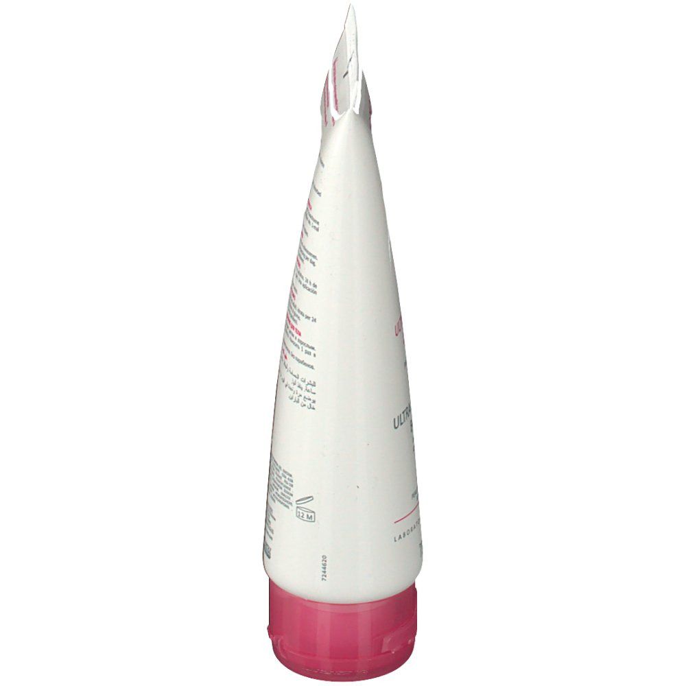 Tube blanc, vue latérale. Bouchon rose. Texte et symboles.