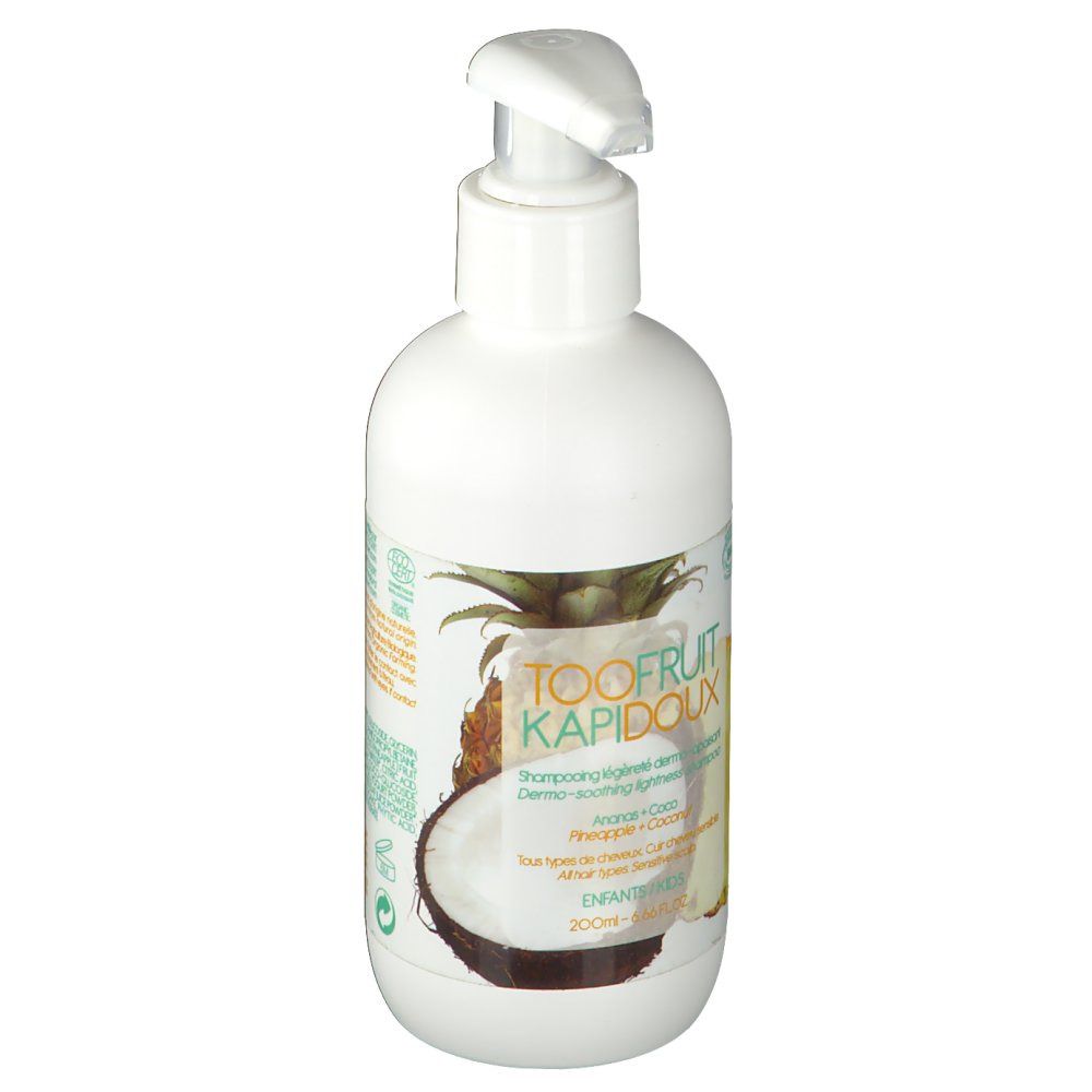 Flacon blanc avec pompe. Étiquette avec texte, illustrations d'ananas et noix de coco. Nom du produit visible.