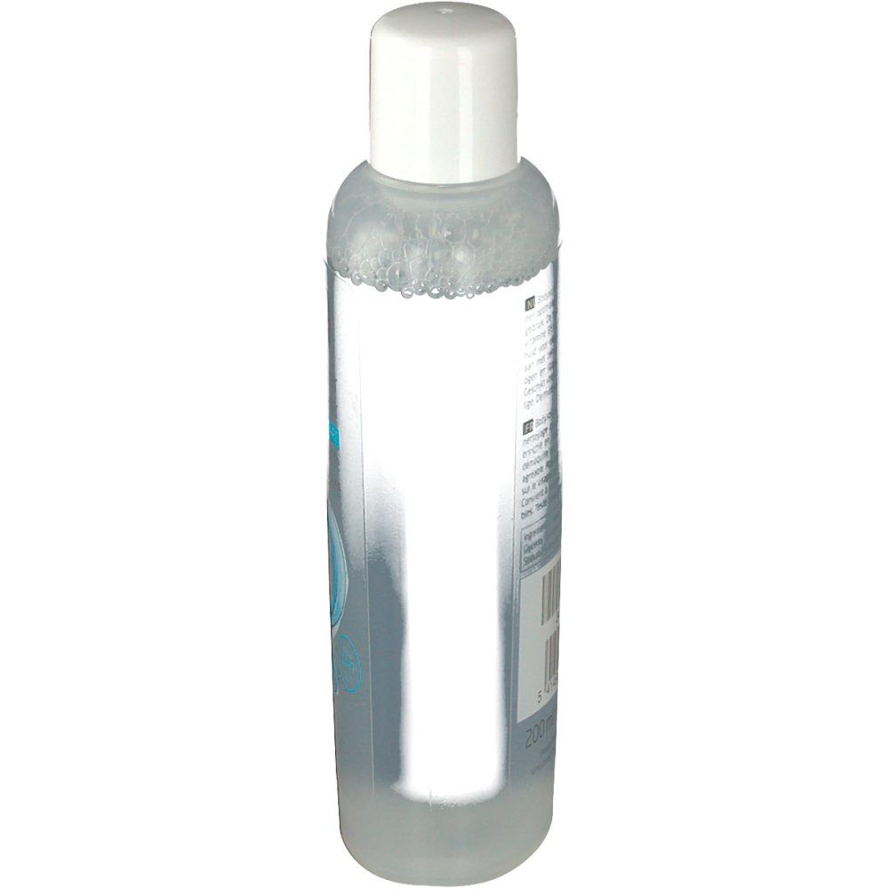 Flacon transparent avec bouchon blanc. Étiquette avec texte et code-barres au dos.