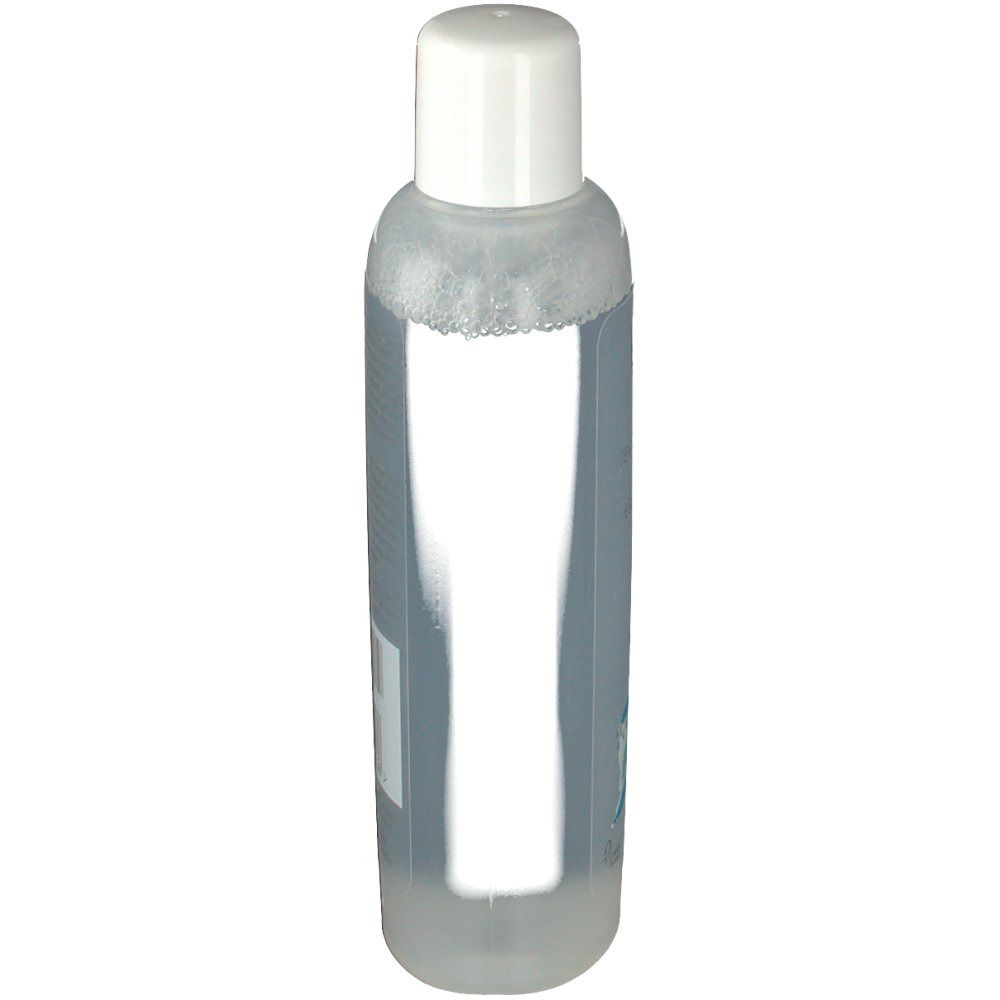 Flacon transparent avec bouchon blanc. Dos avec étiquette, texte et code-barres.