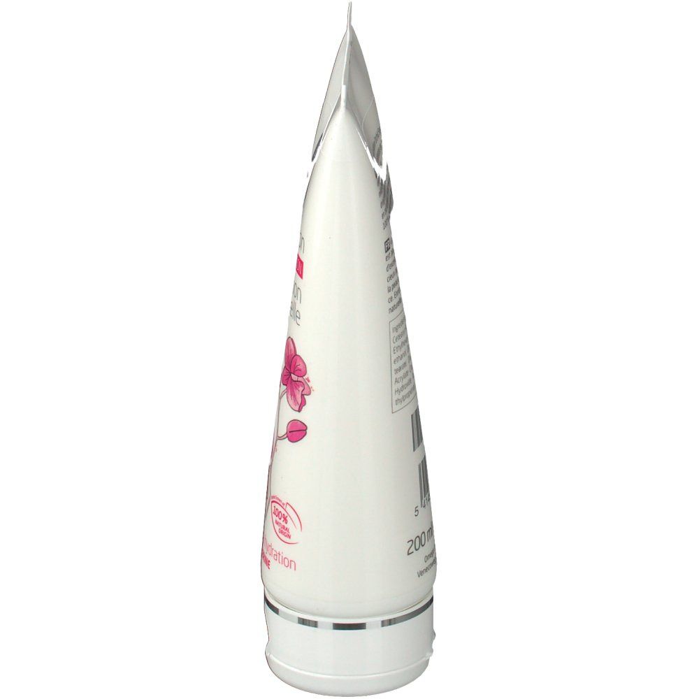 Vue latérale d'un tube blanc. Contient du texte et une illustration d'orchidée.