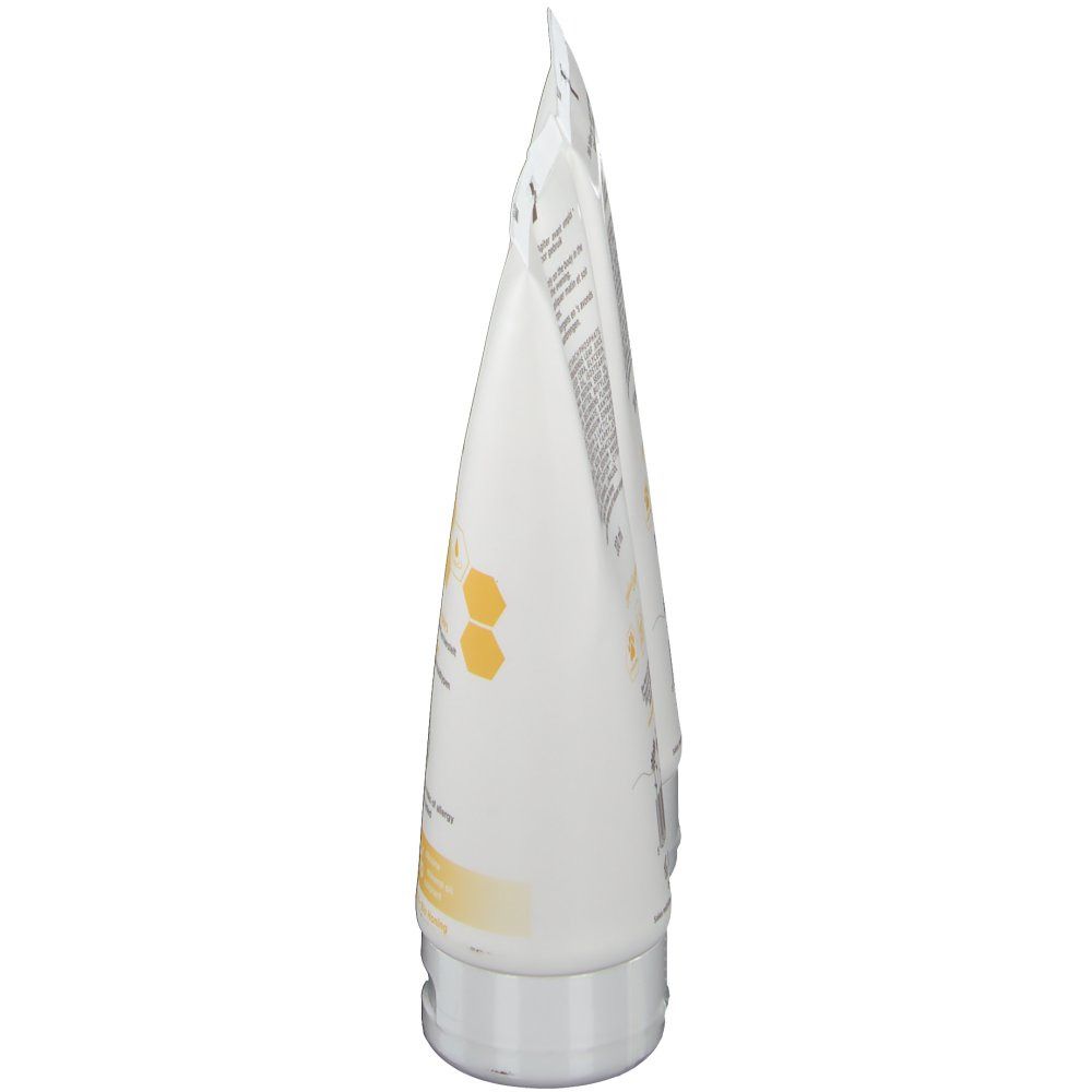 Vue latérale d'un tube de Body Milk. Tube blanc avec informations produit. Bouchon gris.