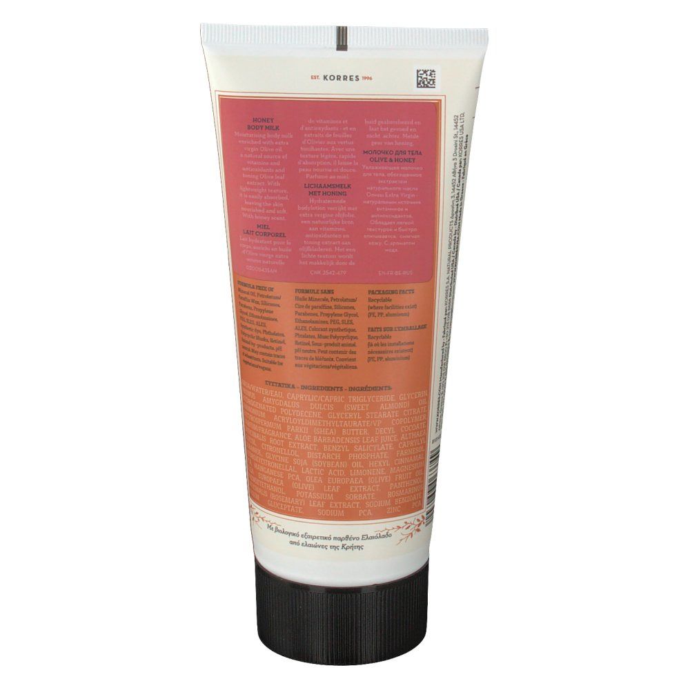 Dos du tube. Texte en plusieurs langues. Zones de couleur rose et beige. Bouchon noir.