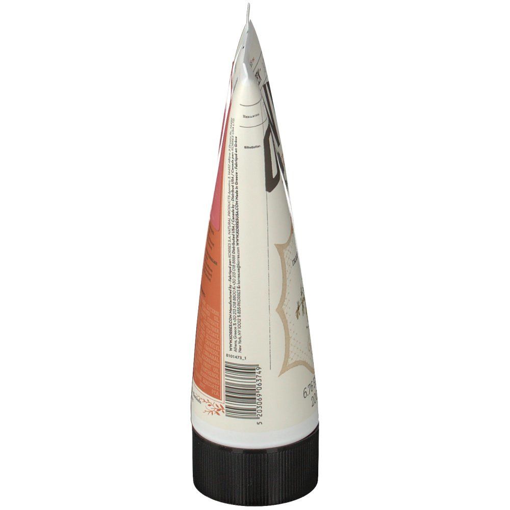 Vue latérale du tube. Blanc, avec texte et zone rose. Bouchon noir. Pointe fermée.