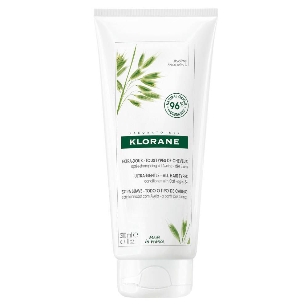 Tube blanc avec étiquette verte. Inscription KLORANE, 96% ingrédients naturels. Texte: Extra-Doux, Ultra-Gentle, Extra Suave.
