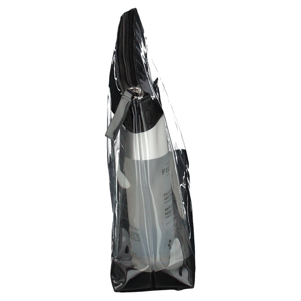 Trousse de toilette transparente avec fermeture éclair noire. Contient une bouteille blanche. Vue latérale.