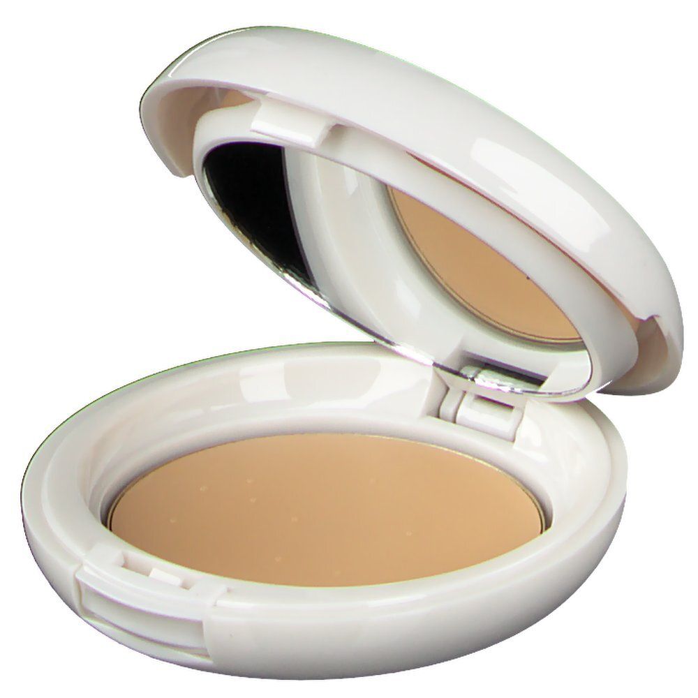 Maquillage compact beige doré dans un boîtier ovale blanc ouvert, avec miroir.