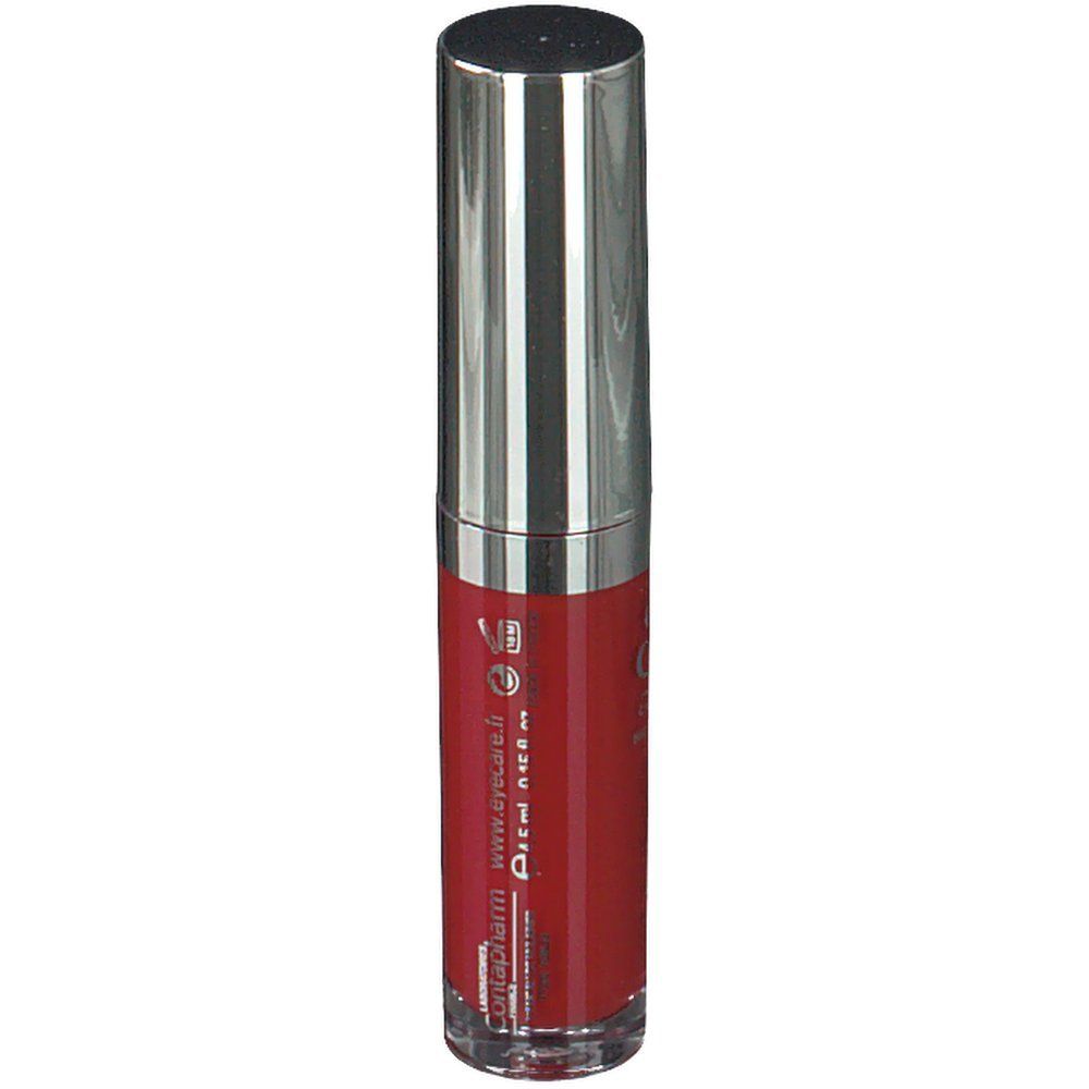 Rouge à lèvres liquide rouge dans un flacon cylindrique transparent avec un capuchon argenté. Inscription : Eye Care.