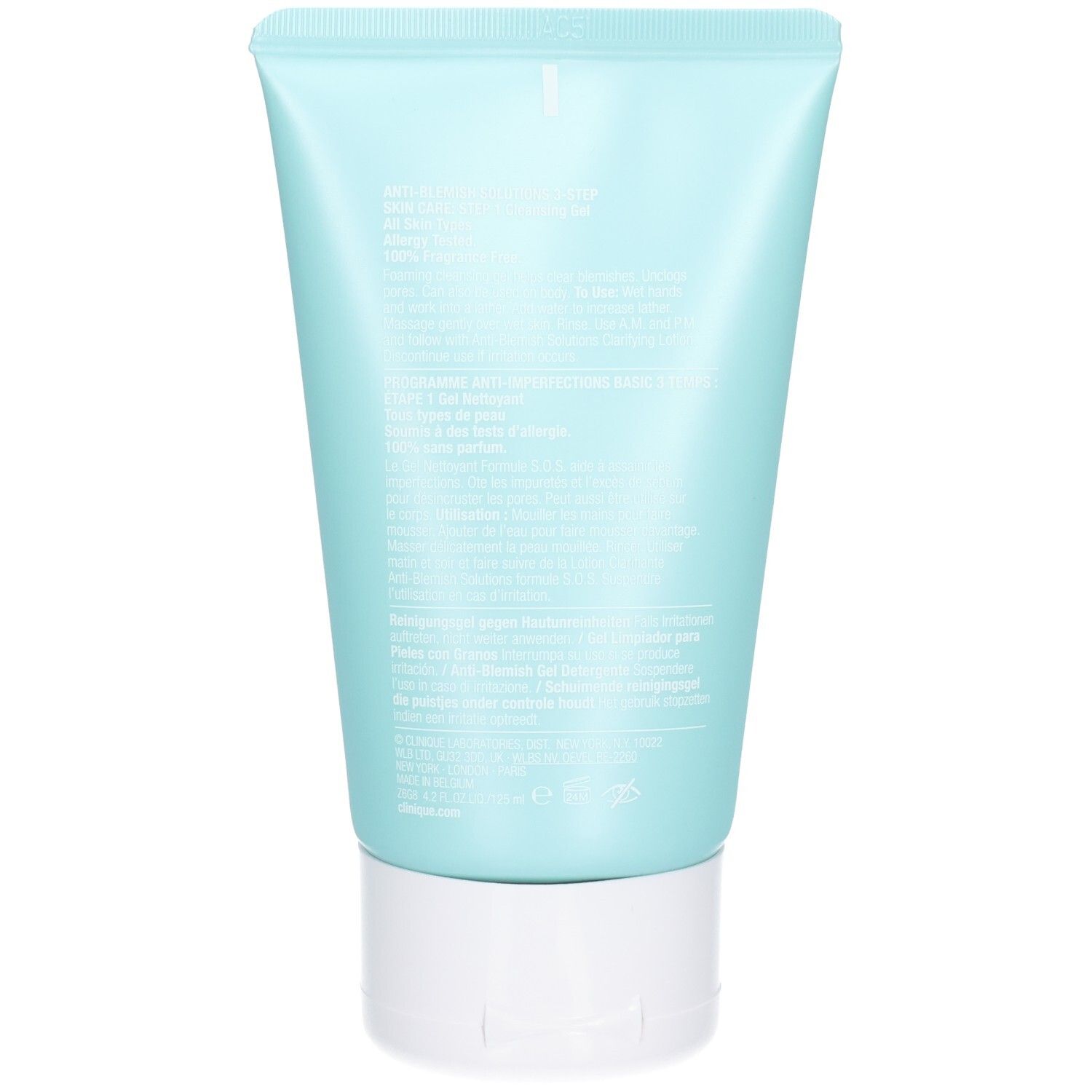 Dos d'un tube bleu clair avec bouchon blanc. Texte multilingue. Pas de marque ni de nom de produit visible.