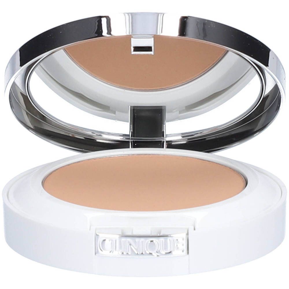 Poudre compacte avec miroir. Boîtier blanc avec poudre beige. Marque Clinique visible.