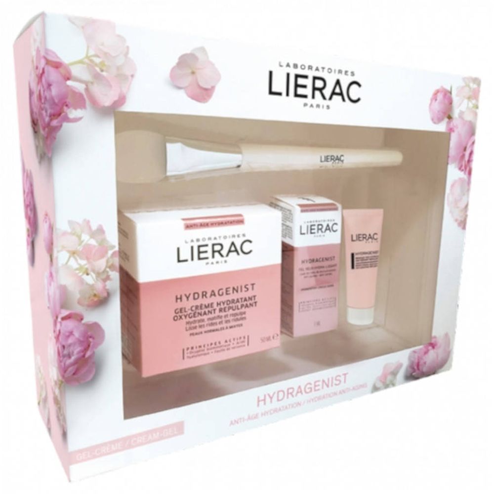 Coffret cadeau avec produits cosmétiques et pinceau. Emballage rose et blanc avec motifs floraux. Marque Lierac.
